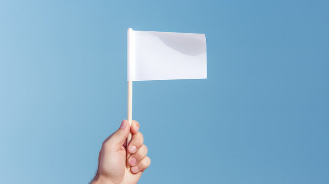 Hand Raising a White Flag - Illustrates Surrendering, Yielding, or Admitting Defeat / Loss.