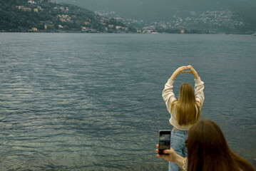 person taking a picture of a lake