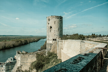 panoramic view of a French medieval castle tower on the edge of a river 