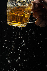Beer with foam splash. Freeze motion splash drops of beer foam. vertical image. place for text