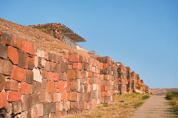 Restored walls of the ancient fortress of Erebuni, the kingdom of Urartu in present-day Yerevan,...