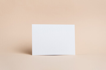 Blank paper card mockup with copy space on beige background