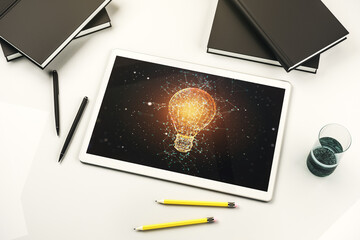 Creative idea concept with light bulb illustration on modern digital tablet screen. Top view. 3D Rendering