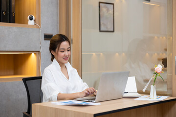 Asian woman. Happy excited successful Beautiful businesswoman triumphing in modern office with laptop Work from home and social distancing concept