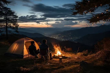 Fotobehang Two people camping outdoors, sitting next to a tent, a campfire burning beside them, rolling mountains and forests in the distance,Generative AI © dhiyaeddine