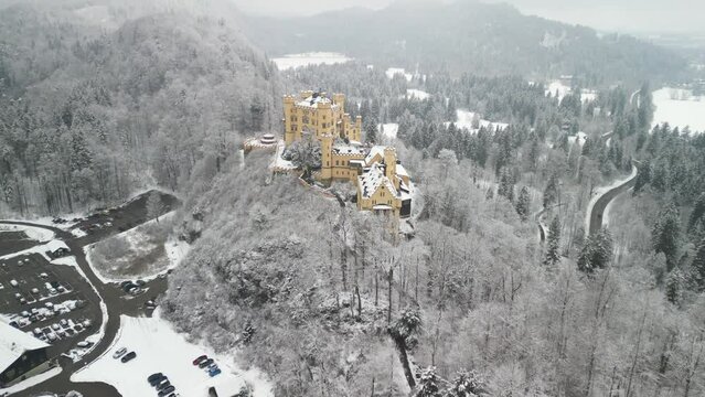 Aerial View from Hohenschwangau Castle recorded in winter with light snow covered mountains and bare trees in the alpine in the south of Bavaria