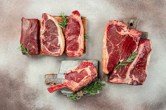 Variety of fresh Black Angus Prime raw beef steakes on a light background. banner, menu, recipe place for text, top view