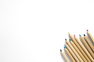 Obraz premium Wooden multi-colored pencils on a white background, isolated, top view.
