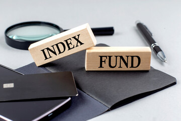 INDEX FUND text on wooden block on black notebook , business concept