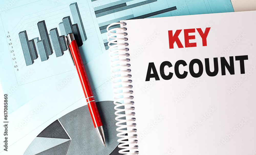Poster key account text on a notebook with pen on a chart background