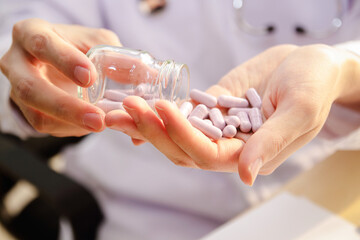 Doctor or pharmacist holding medicine or vitamin in hand. Medical treatment, pharmacy or health insurance.