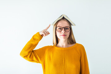 Young woman in eye glasses with book. Happy positive smart girl, education concept	