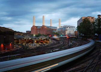 Battersea Power Station at dusk with train and moody sky