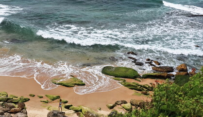 Waves, rocks and sand at Bondi Beach southwesternmost point seen from Notts Avenue....