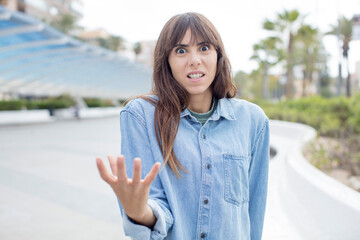 pretty young woman looking angry, annoyed and frustrated screaming wtf or what’s wrong with you