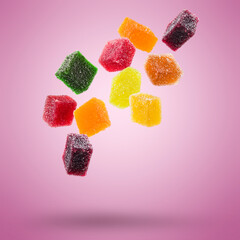 assorted jelly candies floating on colored background. - 617099277