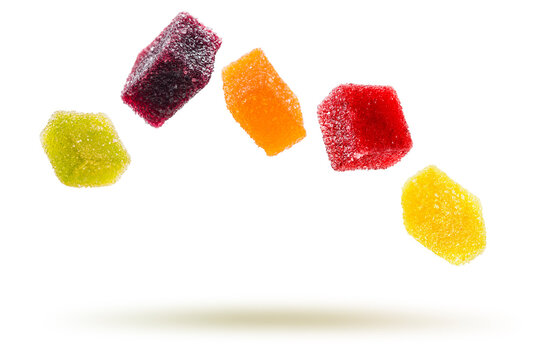 assorted jelly candies floating on white background.
