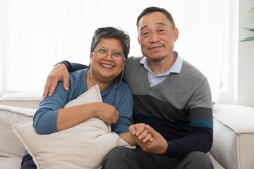 Happy smiling Asian elderly couple hugging together at home. Retirement, health care, relax and spending time concept