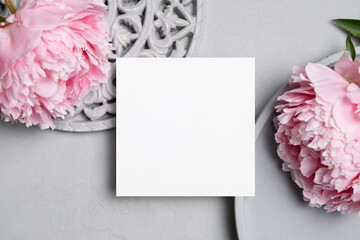 Square paper card mockup with pink peony flowers, blank invitation, greeting or flyer card mock up