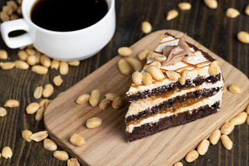 a piece of chocolate cake with caramel and peanuts