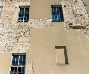 Part of the wall of an old building with damaged plaster