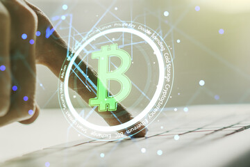 Creative Bitcoin concept with hands typing on computer keyboard on background. Double exposure