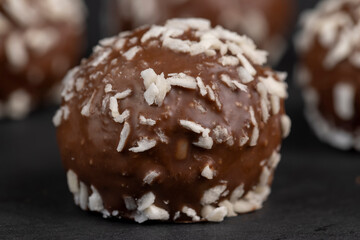 Chocolate candies in the form of balls with milk coconut
