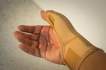 Human hand with elastic Wrist Injury Support.