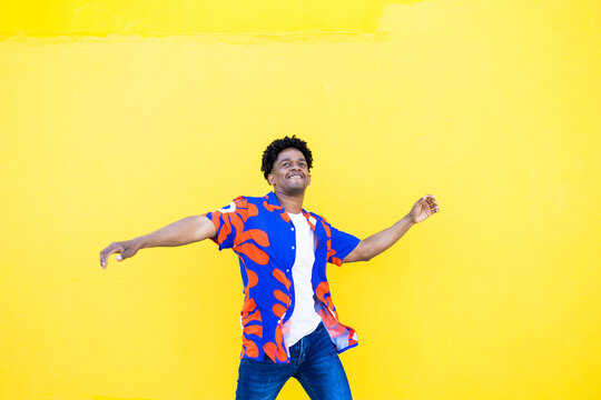Cool man in casual clothes dancing expressively