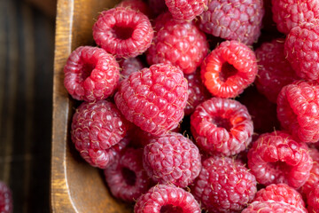 Ripe raspberries on a wooden board