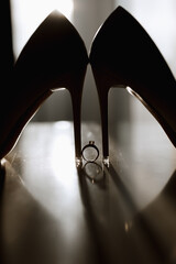 wedding ring white shoes of the bride in soft light