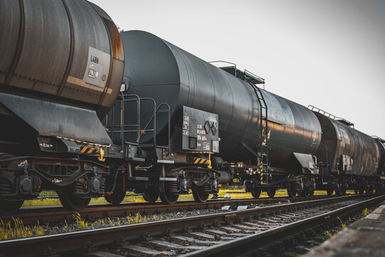 Transportation tank cars with oil during sunset. Railway containers. Freight railway wagons. Railway tank.