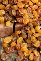 Dried yellow golden raisins on a board
