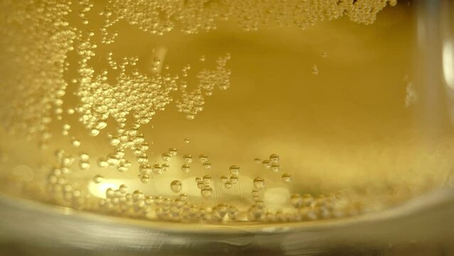 Air bubbles rise from bottom of mug of beer, studio photography