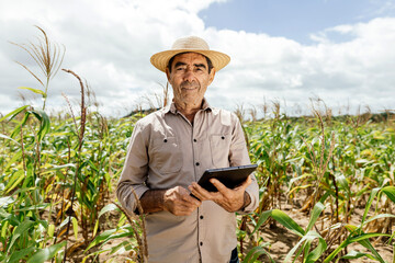 Technology of modern agriculture, farmer working on field with digital tablet in agriculture.