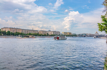 Cruise ship sails on the Moscow river in Moscow city center, popular place for walking.