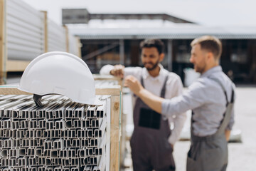 International team. Manager and staff worker inspecting shipping cargo for import and export. A...