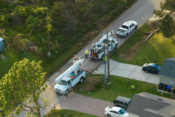 Electrical service company restoring power repairing damaged power lines after hurricane Ian in...