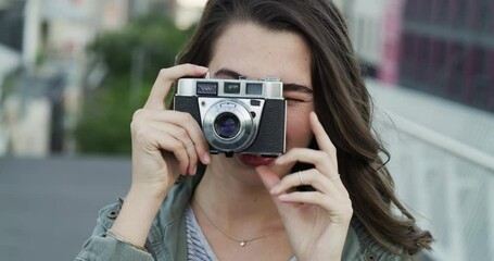 Woman, camera and photography in city with face, smile and travel blogger or influencer outdoor. Female photographer on urban bridge, taking picture and memory with content creation and tourism
