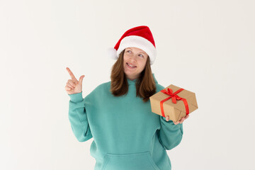 Photo of sweet cute pregnant woman wear green hoodie holding xmas present pointing empty space isolated white color background