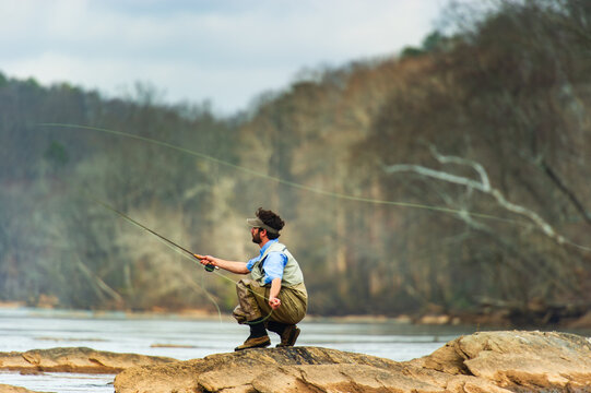 An Egyptian man casts a fly rod on the Chattahoochee River near Long Island Shoals, Atlanta, Georgia