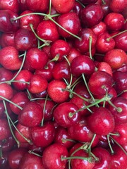 Background filled with the close-up details of ripe red maroon cherries