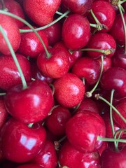 Background filled with the close-up details of ripe red maroon cherries