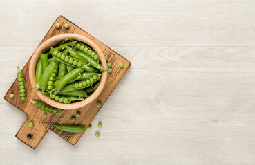 Composition with fresh green peas on wooden background, top view