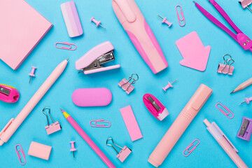 Pink school stationery on color backgroung, top view