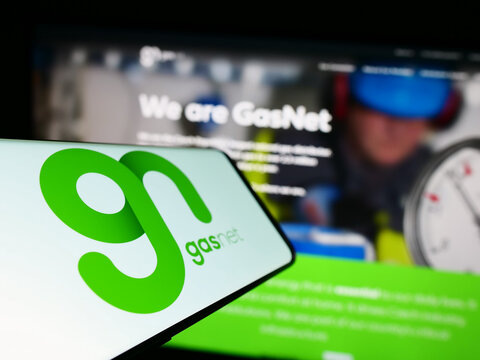 Stuttgart, Germany - 06-18-2023: Smartphone with logo of Czech gas distribution company GasNet sro on screen in front of business website. Focus on center-left of phone display.