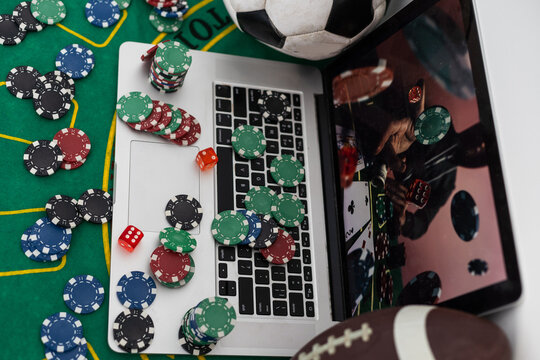 betting bet sport phone gamble laptop over shoulder soccer live home website concept - stock image