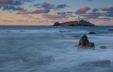 Godrevy lighthouse at sunset in St Ives Bay Cornwall, UK