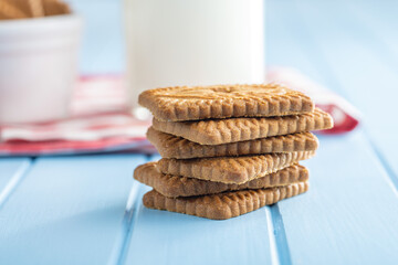Sweet caramel biscuits. Tasty cookies on blue table.