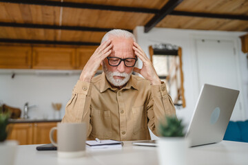 One senior caucasian man work on laptop use computer at home